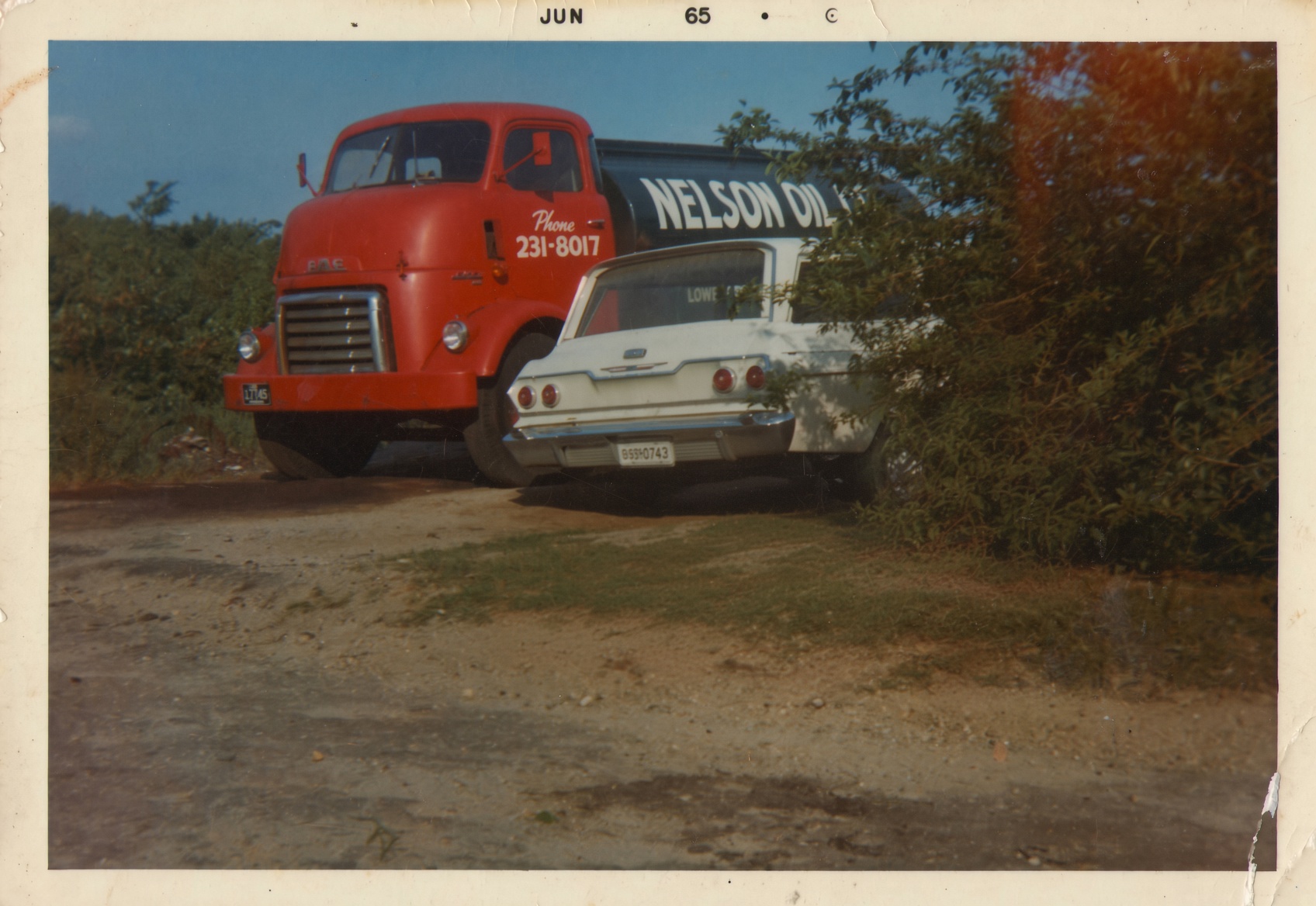 A vintage Nelson Oil delivery truck in a historic photograph